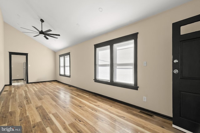 interior space featuring vaulted ceiling, ceiling fan, and light wood-type flooring