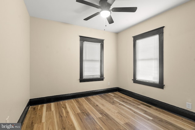 spare room featuring light hardwood / wood-style floors and ceiling fan