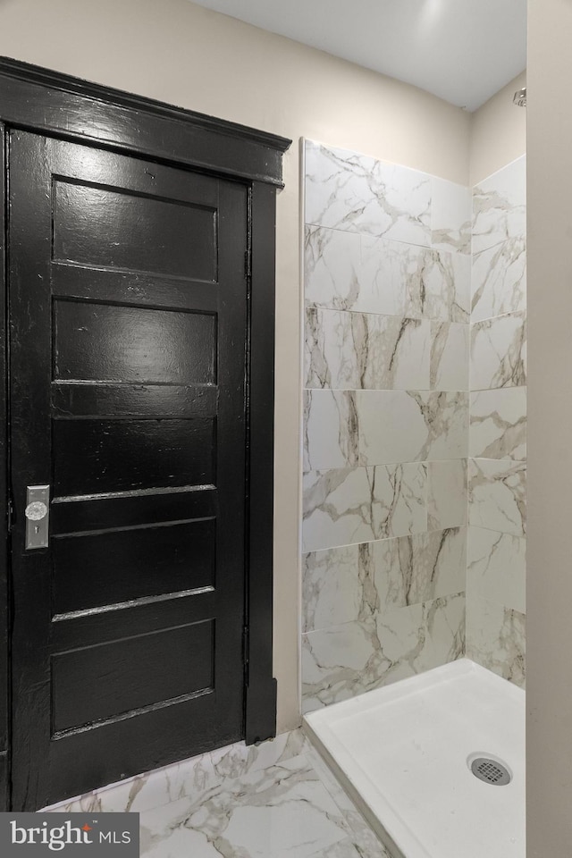 bathroom with tiled shower