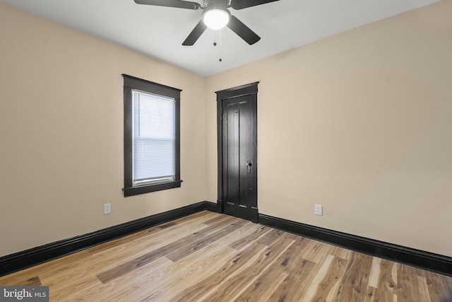 empty room featuring ceiling fan and light wood-type flooring