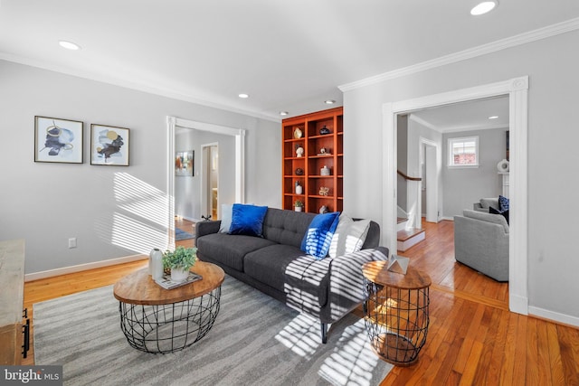 living room with hardwood / wood-style flooring and ornamental molding