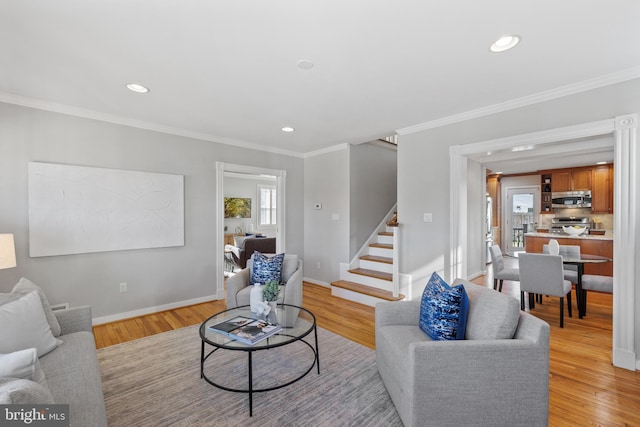 living room with crown molding and light hardwood / wood-style flooring