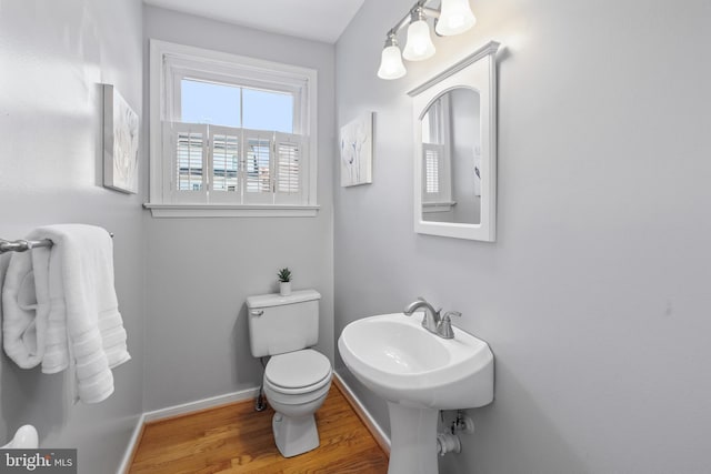 bathroom featuring hardwood / wood-style flooring and toilet