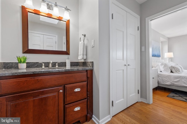 bathroom with hardwood / wood-style flooring and vanity