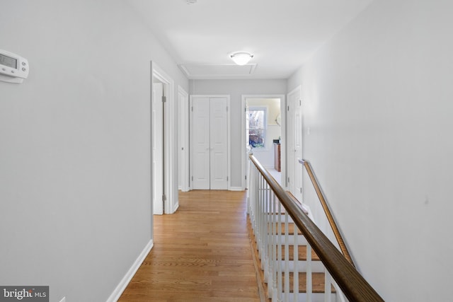 corridor with light hardwood / wood-style floors