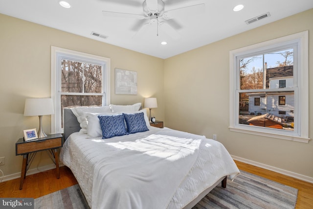 bedroom with hardwood / wood-style floors and ceiling fan