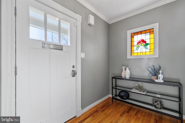 entrance foyer featuring ornamental molding and wood-type flooring