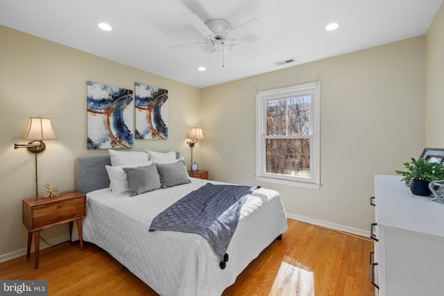 bedroom with ceiling fan and light hardwood / wood-style flooring