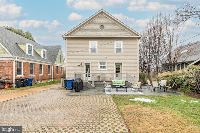 rear view of house with an outdoor hangout area, a yard, and a patio area