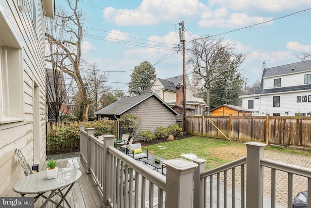 wooden deck featuring a yard