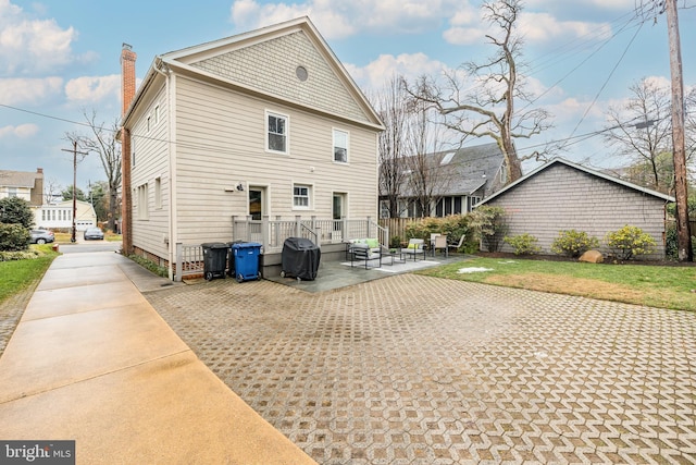 back of property featuring a yard and a patio area