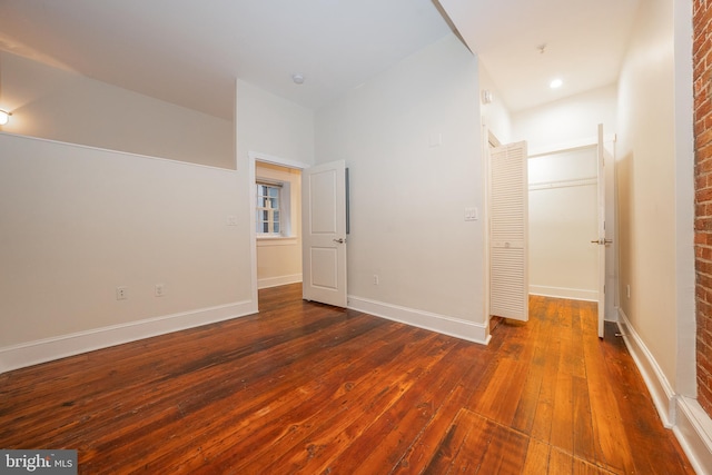 unfurnished room featuring dark wood-type flooring