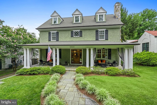 view of front of property with a front yard and a porch