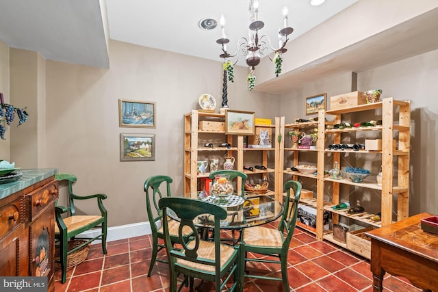 tiled dining area featuring a chandelier