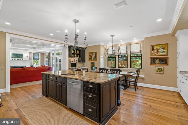 kitchen with sink, dishwasher, ornamental molding, a center island with sink, and decorative light fixtures