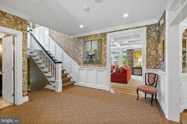 entryway featuring crown molding