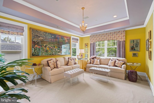 living room featuring crown molding, a notable chandelier, a tray ceiling, and carpet flooring