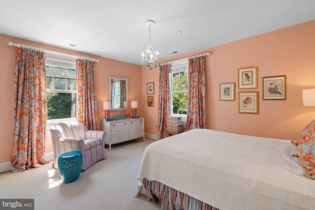 carpeted bedroom featuring a chandelier