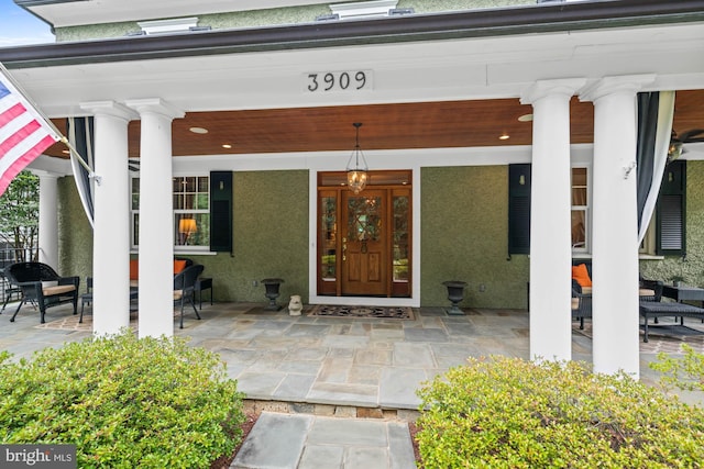 view of exterior entry with covered porch