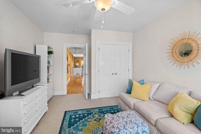 carpeted living room with ceiling fan