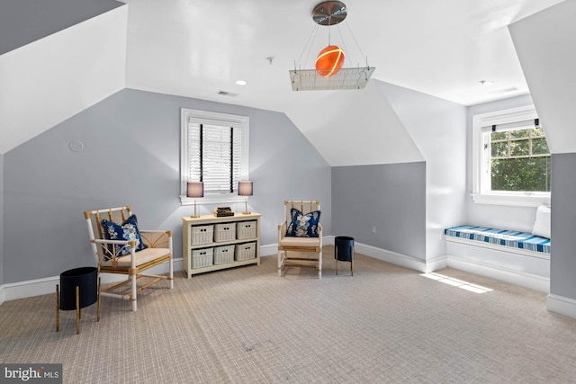 sitting room featuring lofted ceiling and carpet floors