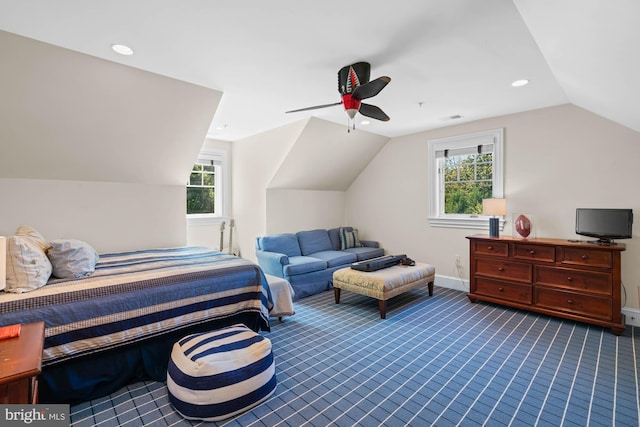 carpeted bedroom with multiple windows, vaulted ceiling, and ceiling fan