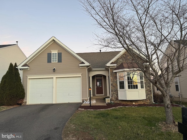 view of front facade with a garage and a yard