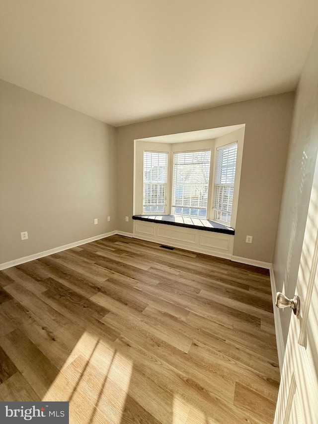 empty room with wood-type flooring