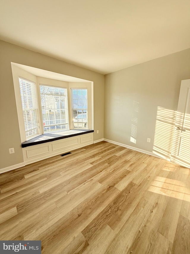 unfurnished room featuring light hardwood / wood-style floors