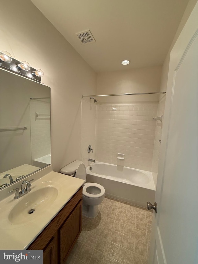 full bathroom featuring vanity, tiled shower / bath combo, and toilet