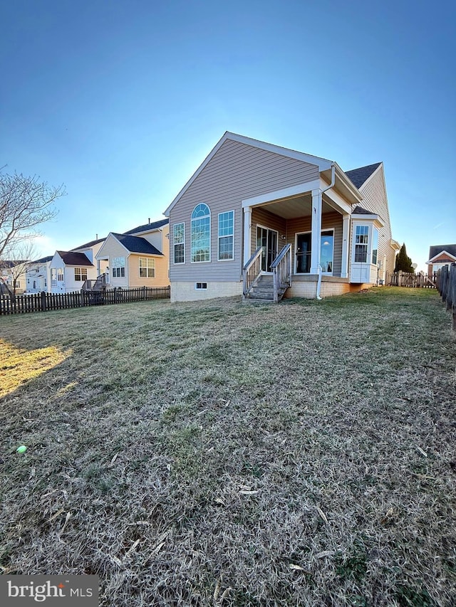 back of house with a porch and a yard