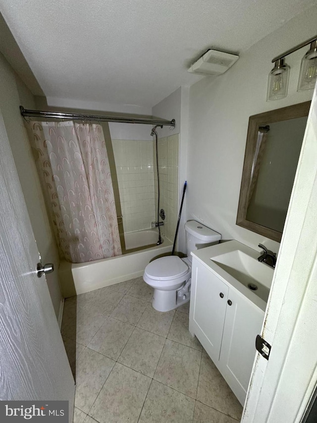 full bathroom featuring shower / tub combo, tile patterned flooring, vanity, a textured ceiling, and toilet