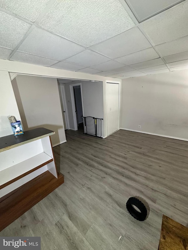 basement featuring hardwood / wood-style floors and a paneled ceiling