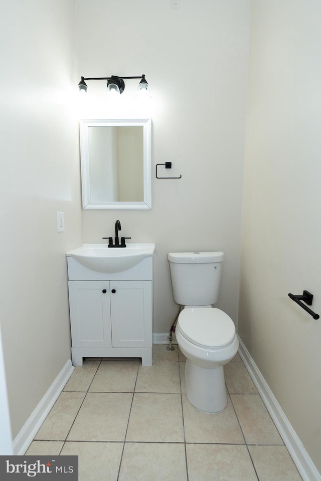 bathroom featuring tile patterned flooring, vanity, and toilet