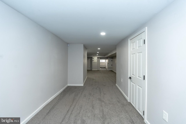 hall with light colored carpet