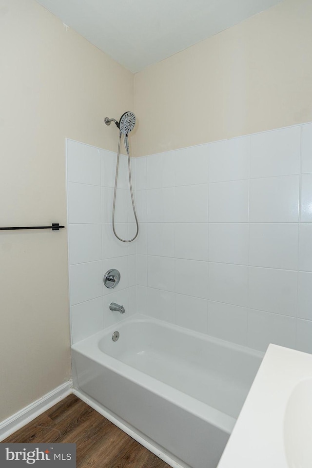 bathroom with tiled shower / bath and hardwood / wood-style floors