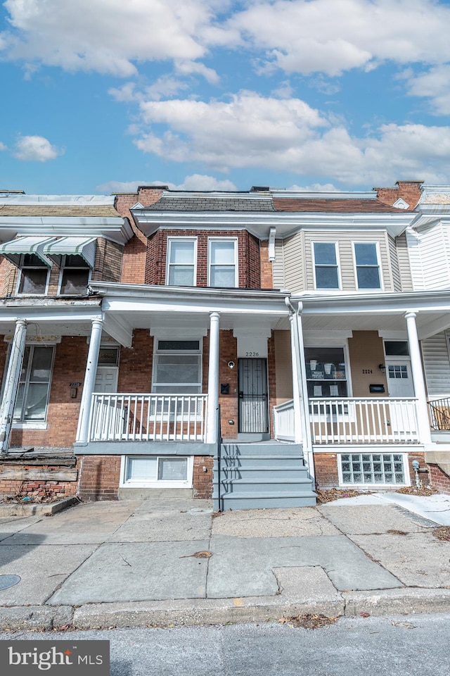 view of property featuring a porch