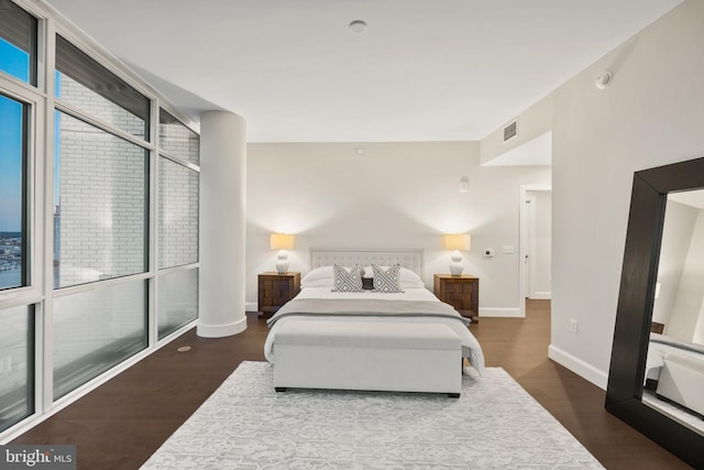 bedroom with dark hardwood / wood-style flooring