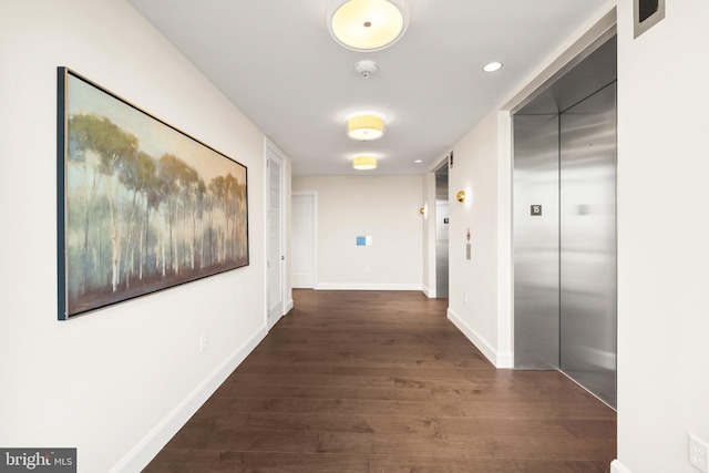 hall featuring dark wood-type flooring and elevator