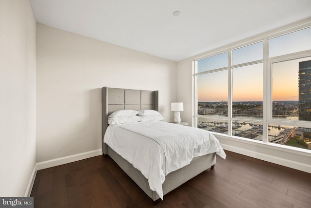 bedroom with dark wood-type flooring