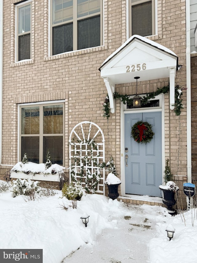 2256 S Glebe Rd, Arlington, VA 22206 - snow covered property entrance featuring brick siding