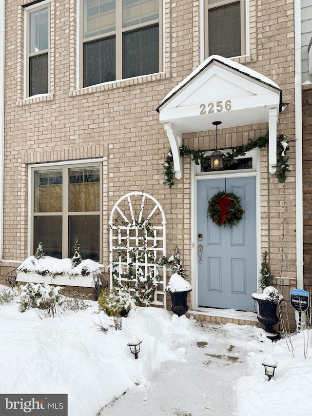 view of snow covered property entrance