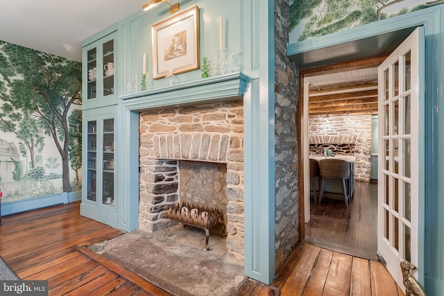 interior space with wood-type flooring and beam ceiling