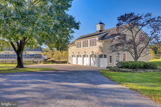 view of front of house featuring a garage and a front yard