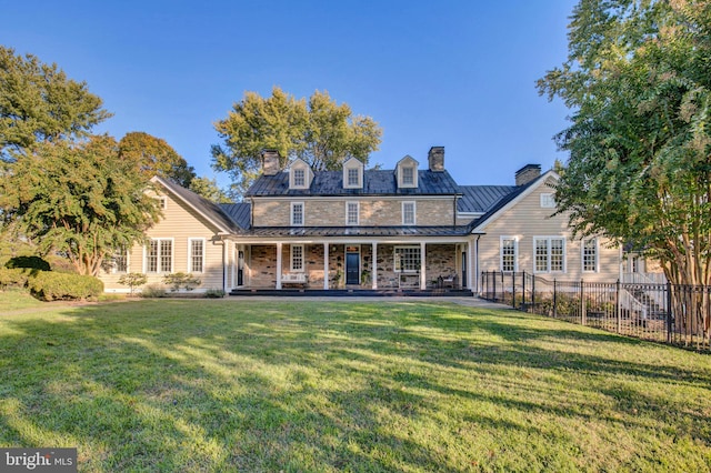 rear view of house with a yard