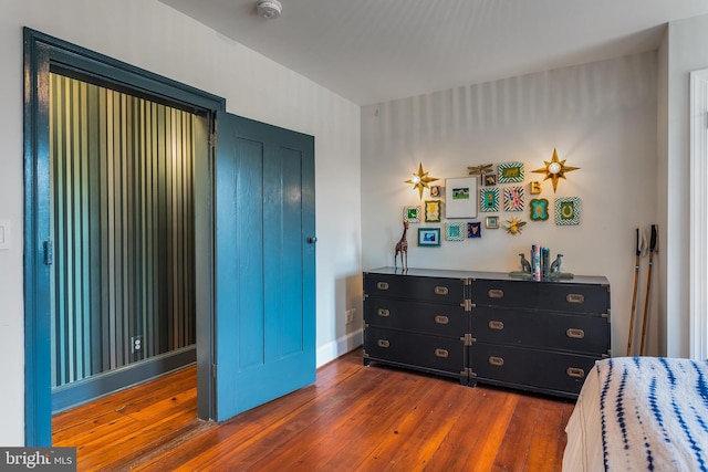 bedroom with dark hardwood / wood-style floors