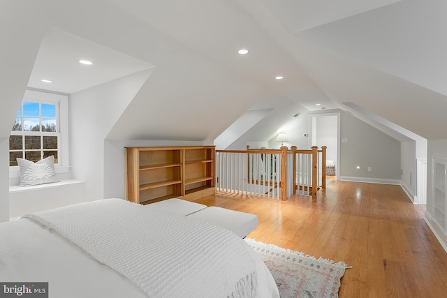 bedroom featuring wood-type flooring and vaulted ceiling