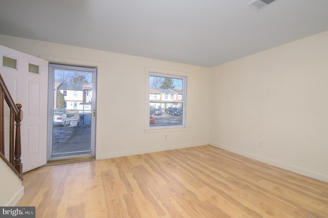 foyer with a wealth of natural light and light wood-type flooring