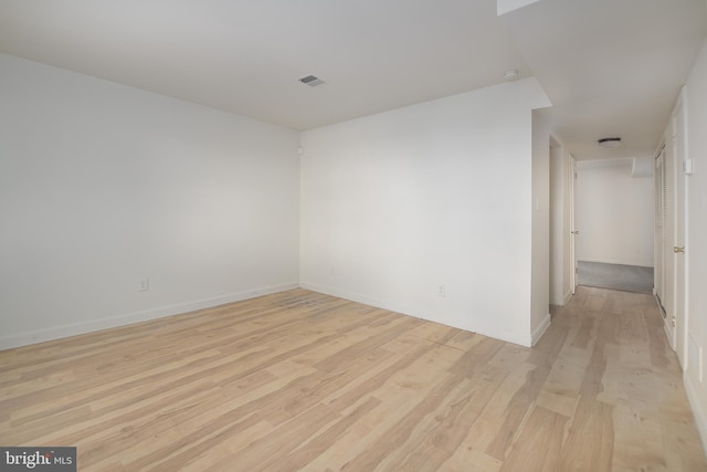 spare room with light hardwood / wood-style flooring