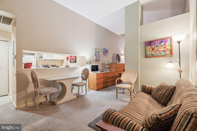 carpeted office space with vaulted ceiling